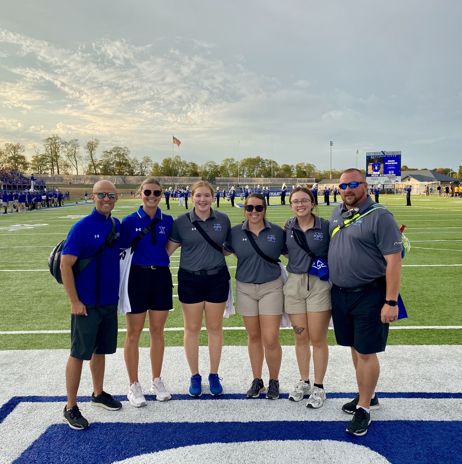 Michael Gordon with the St. Xavier athletic training staff on the field