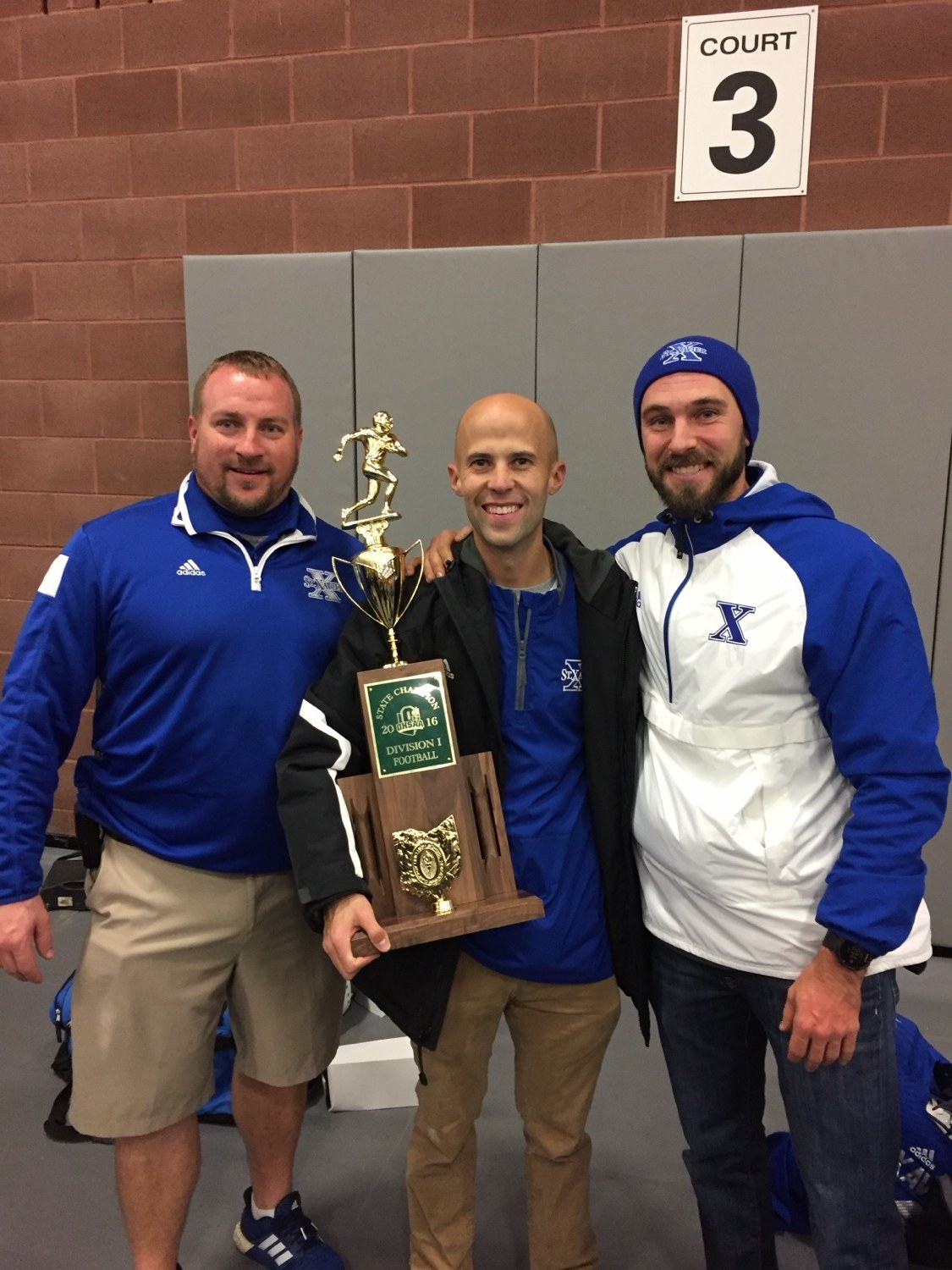 St. Xavier athletic training staff with the state championship trophy
